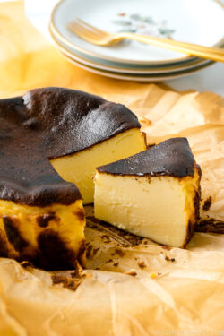 A slice of Basque Burnt Cheesecake on parchment paper.