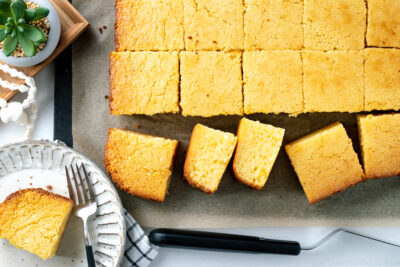 Slices of butter mochi on the cutting board.