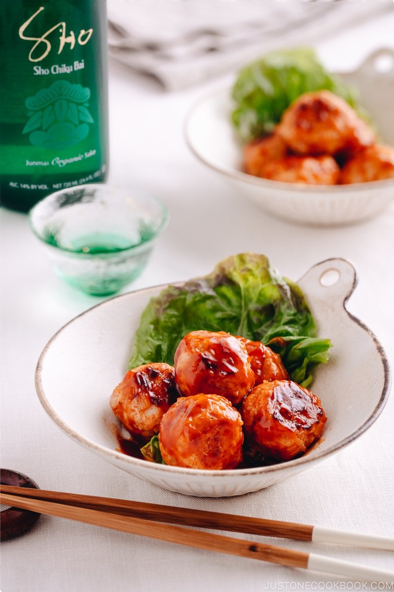 A white dish containing Chicken Meatballs with Sweet and Sour Sauce.