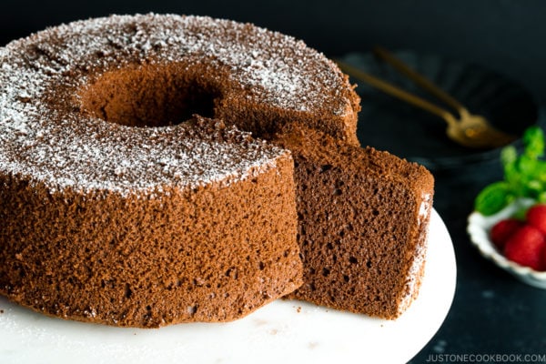 A chocolate chiffon cake served on a cake stand.