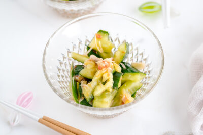 Glass bowls containing Smashed Cucumber Salad with Ume Dressing.