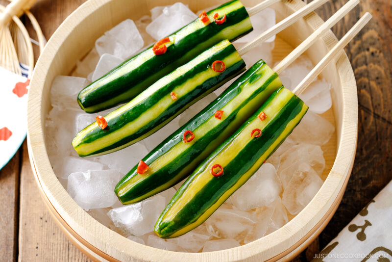 Japanese Cucumbers on a Stick served over iced cubes in wooden bowl.