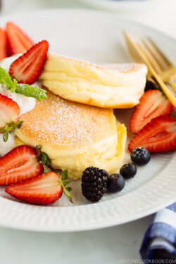 A white plate containing fluffy Japanese souffle pancakes.