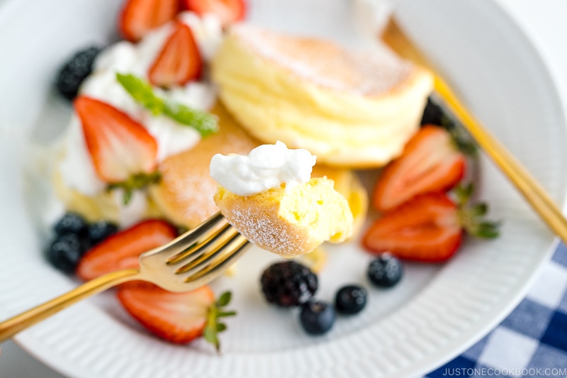 A white plate containing fluffy Japanese souffle pancakes.