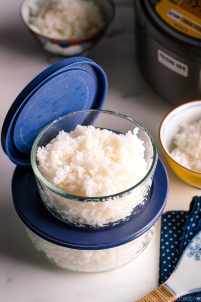 Glass airtight containers with steamed rice in them.