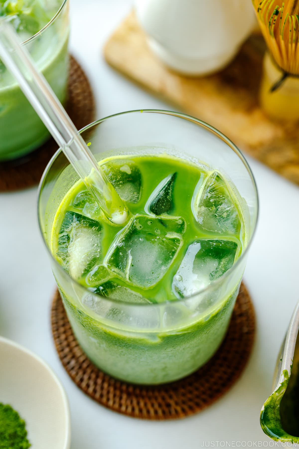 Tall glass cups containing Iced Matcha Latte.