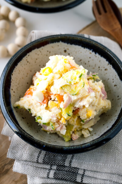 A ceramic bowl containing the Japanese potato salad.