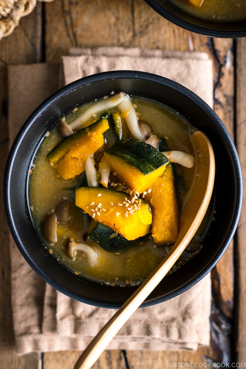 Kabocha Miso Soup served in a black bowl.