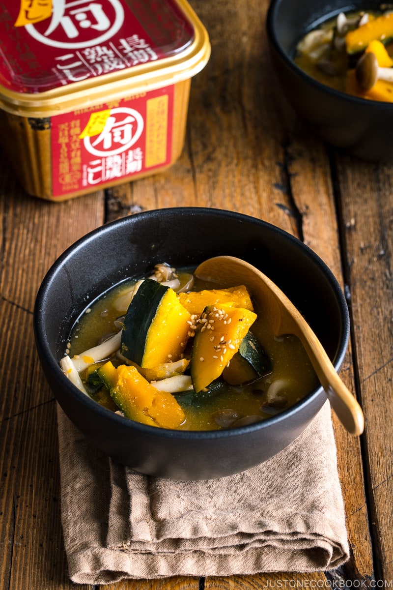 Kabocha Miso Soup served in a black bowl.