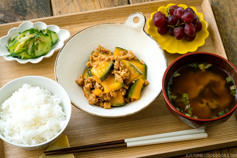 A white ceramic containing Kabocha Pork Stir Fry.