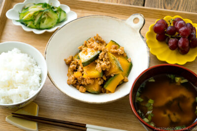 A white ceramic containing Kabocha Pork Stir Fry.