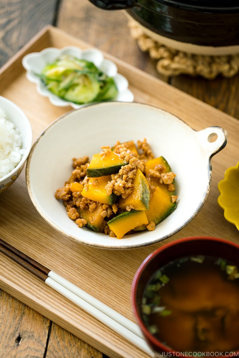 A white ceramic containing Kabocha Pork Stir Fry.