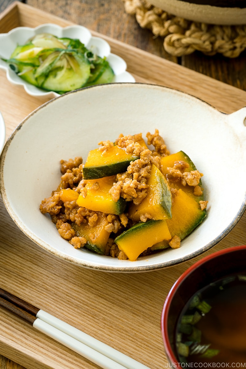 A white ceramic containing Kabocha Pork Stir Fry.