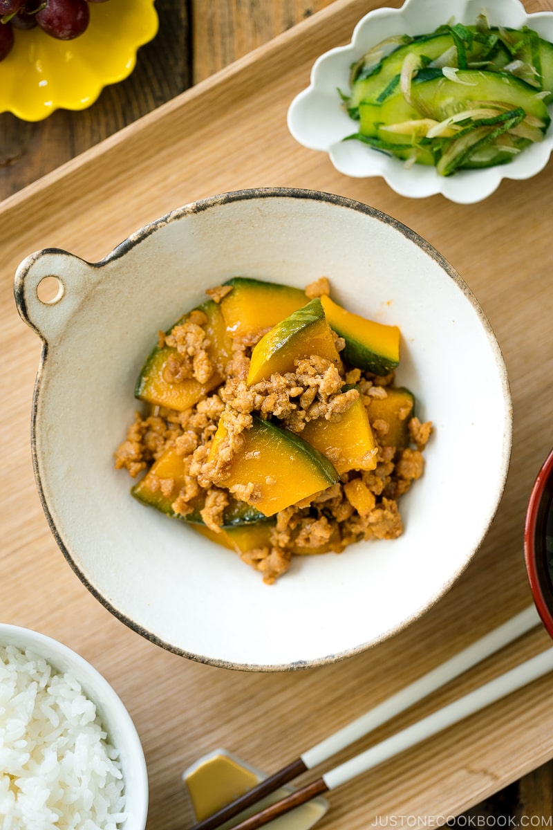 A white ceramic containing Kabocha Pork Stir Fry.