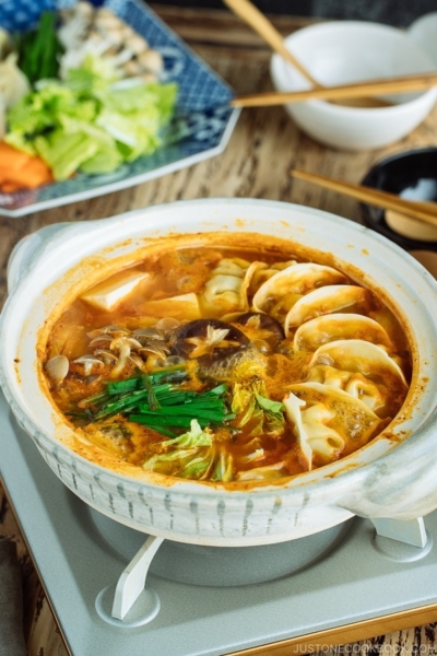 Kimchi Gyoza Nabe served in donabe (Japanese earthenware pot).