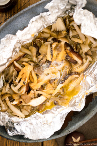 Drizzling of soy sauce over miso butter mushrooms.