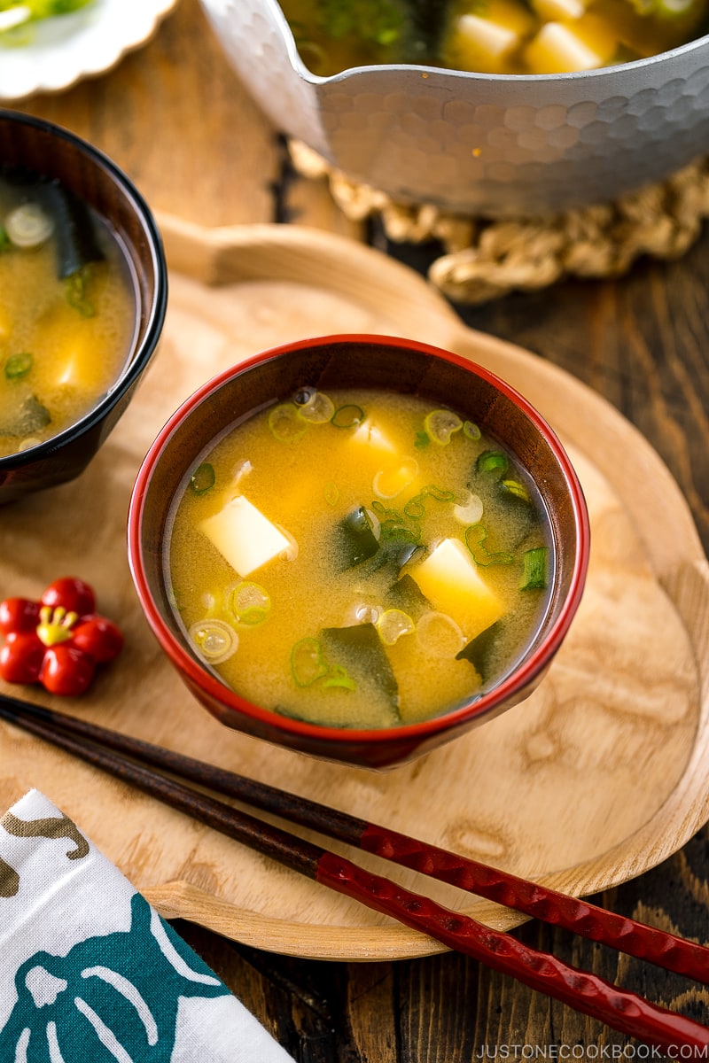 Japanese miso soup bowls containing tofu and wakame miso soup.