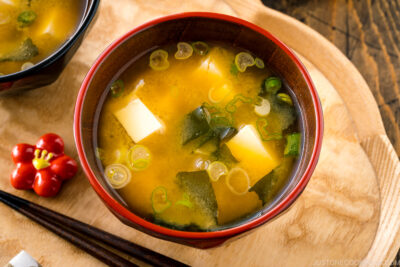 Japanese miso soup bowls containing tofu and wakame miso soup.