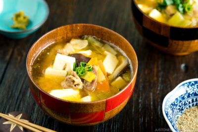 A wooden soup bowl containing miso soup.