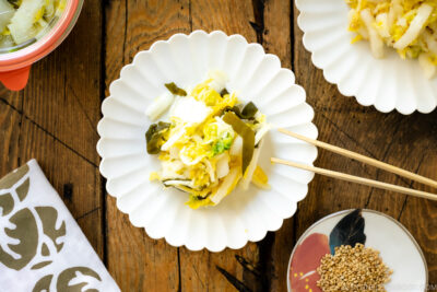 A white ceramic plate containing Napa Cabbage Pickles (Tsukemono).