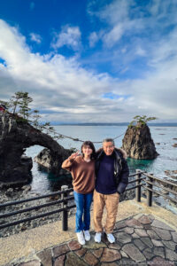 a older man and girl standing on a viewing platform