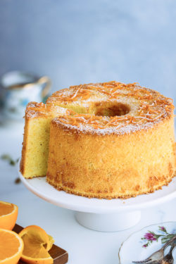 Orange chiffon cake served on a cake stand.