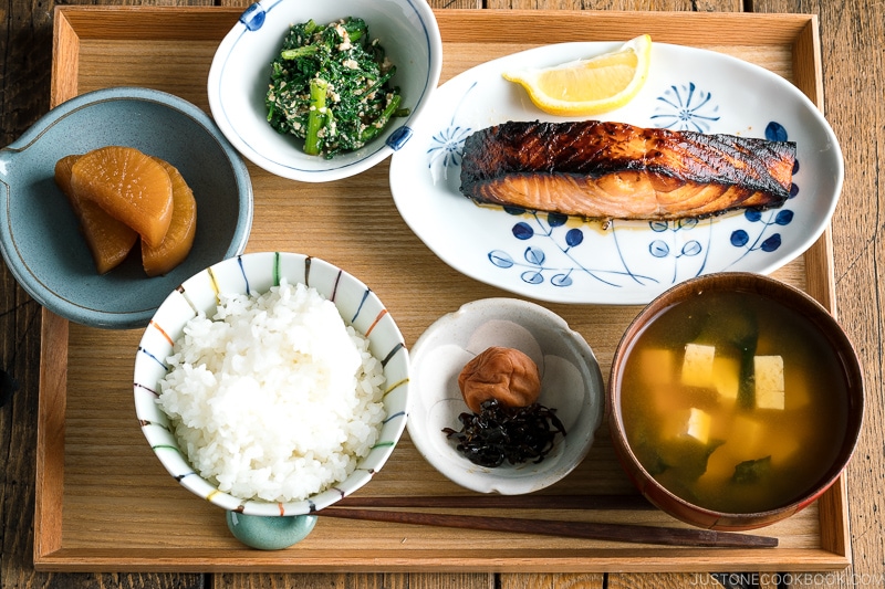 A Japanese meal set with shio koji salmon, miso soup, rice, and side dishes.