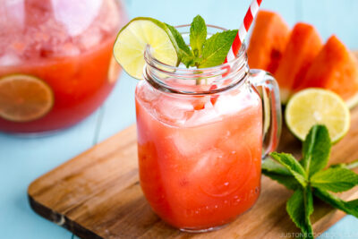 A glass jar containing homemade watermelon juice.